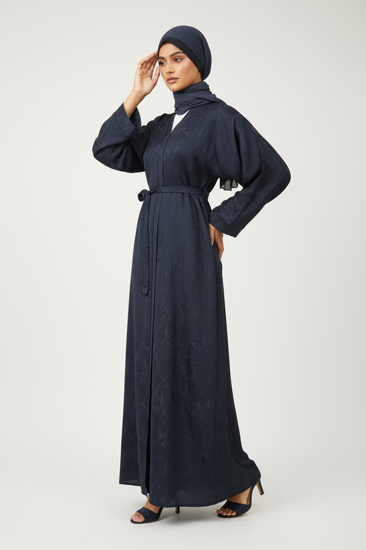 Woman wearing a long dark blue dress with a matching hijab