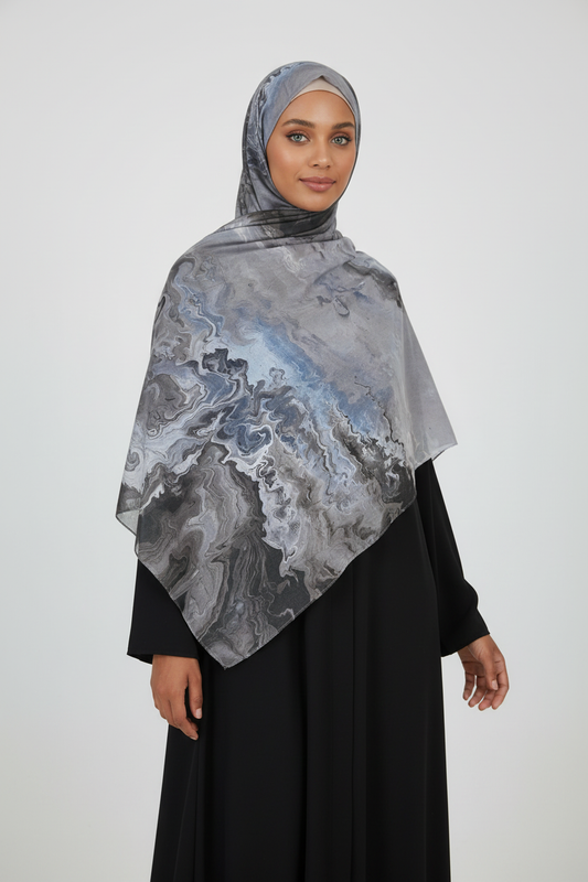 Woman wearing a gray and blue patterned hijab 